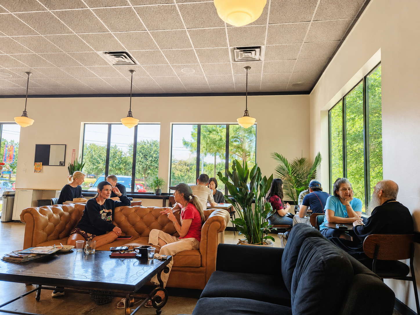 The 33 Peaks Cafe lounge in Southlake — leather sofas, tall windows, and guests relaxing together